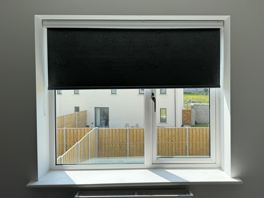 Best blinds for bedrooms shown as a blackout roller blind in a bright Meath bedroom